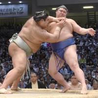 Ozeki Takayasu forces Shodai out of the raised ring on Saturday during their Nagoya Grand Sumo Tournament match at Aichi Prefectural Gymnasium. | KYODO