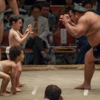 Shohozan faces off against two children during the Ozumo Beyond 2020 event on Oct. 4, 2016 at Ryogoku Kokugikan. | JOHN GUNNING
