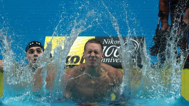 Caeleb Dressel reacts after winning the men’s 100-meter butterfly final at the world swimming championships on Saturday in Budapest. Dressel wins unprecedented three golds in same night