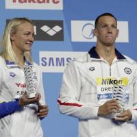 Sarah Sjostrom (left) Caeleb Dressel show off their awards after being selected as the best athletes of the world swimming championships on Sunday in Budapest. Dressel matches Phelps with seventh gold of world championships