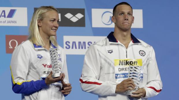 Sarah Sjostrom (left) Caeleb Dressel show off their awards after being selected as the best athletes of the world swimming championships on Sunday in Budapest. Dressel matches Phelps with seventh gold of world championships
