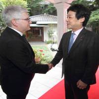 Colombian Ambassador Gabriel Duque (left) welcomes State Minister for Foreign Affairs Kentaro Sonoura during a reception to celebrate Colombia\'s independence at the ambassador\'s residence on July 20. | COURTESY OF THE COLOMBIAN EMBASSY
