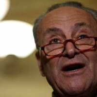 Senate Minority Leader Chuck Schumer speaks with reporters following party luncheons on Capitol Hill in Washington Tuesday. Schumer urges Trump to block Chinese M&As in U.S. until Beijing helps rein in North Korea