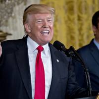U.S. President Donald Trump speaks as billionaire Terry Gou, chairman of Foxconn Technology Group, listens during an event in the East Room of the White House in Washington on July 2. Trump announced that Foxconn Technology Group plans a new factory in Wisconsin, fulfilling the Taiwanese manufacturing giants promise to invest in the U.S. Foxconn steers clear of Trump's $30 billion investment claim