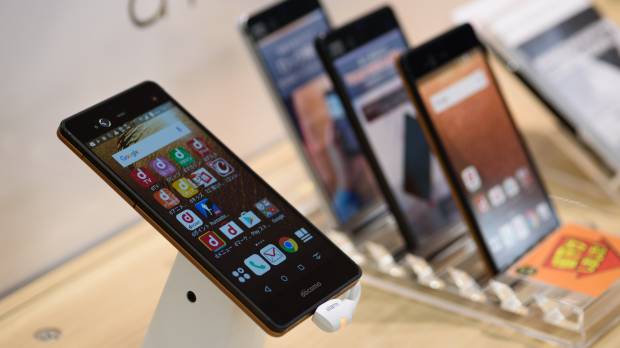Fujitsu Ltd. Arrows NX smartphones are seen on display at an NTT Docomo Inc. store in Tokyo. The electronics manufacturer is reportedly considering selling its mobile phone business after struggling in the market. Fujitsu looks to sell struggling mobile phone business