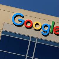 The Google logo is seen atop an office building in Irvine, California, Monday. Axed Google memo writer draws jeers, cheers and job offer from Assange