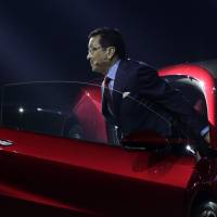 Takahiro Hachigo, president and chief executive officer of Honda Motor Co., steps out of the company’s NSX supercar as he attends a launch event in Tokyo. In alliance-happy auto industry, go-it-alone Honda the odd carmaker out