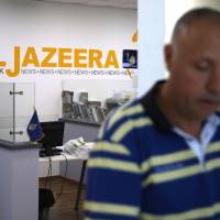 An employee of the Qatar-based news network and TV channel Al-Jazeera is seen at the channel’s Jerusalem office on July 31. Israel said Sunday that it planned to close the offices of Al-Jazeera after Prime Minister Benjamin Netanyahu accused the Arab satellite news broadcaster of incitement. Israel follows Arab states' lead, looks to boot Al-Jazeera over allegations it incited violence