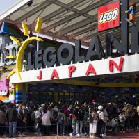 Visitors wait in long lines to enter the Legoland Japan theme park in Nagoya in March, before its grand opening on April 1. Four months later, the outdoor theme park is seeking to address criticism that its ticket prices are too expensive. Legoland Japan finds its reputation for high prices hard to shake