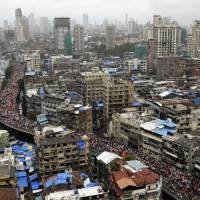 Members of Maratha Kranti Morcha, or Maratha Revolutionary Front, take out a silent march in Mumbai, India, Wednesday. Tens of thousands of people waving saffron flags marched through Mumbai demanding quotas in government jobs and education for the Maratha community in western India. 200,000 protesters grind India financial hub of Mumbai to halt to demand jobs, college