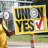A United Auto Workers supporter uses a bullhorn to remind workers to vote while standing outside an employee vehicle entrance at the Nissan vehicle assembly plant in Canton, Mississippi, on Friday. In UAW's latest setback, Nissan plant in Mississippi votes against unionization