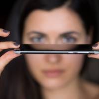 A worker holds the Nokia 8 smartphone, designed by HMD Global Oy, ahead of its official unveiling in London Tuesday. The phone will feature a “dual-sight” photo and video function, in which images from the front and rear cameras will be displayed simultaneously on a split screen. New Nokia 8 phone targets video-streaming fans with split screen, surround sound