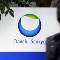 A pedestrian passes Daiichi Sankyo Inc.’s headquarters in Tokyo. Daiichi Sankyo settles U.S. lawsuits over intestinal damage from blood-pressure drugs, paying $300 million