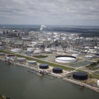 Oil refinery storage tanks stand in this aerial photograph taken above Texas City, Texas, Wednesday. Unprecedented flooding from the Category 4 storm that slammed into the state’s coast last week, sending gasoline prices surging as oil refineries shut, may also set a record for rainfall in the contiguous U.S., the weather service said Tuesday. Quarter of U.S. fuel output shut down by Harvey, sending prices up, supply down