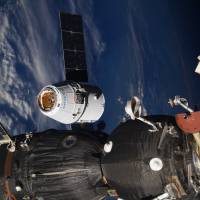 In this photo taken by Russian astronaut Sergey Ryazanskiy, the SpaceX Dragon capsule arrives at the International Space Station on Wednesday. The capsule pulled up Wednesday following a two-day flight from Cape Canaveral, Florida. SpaceX Dragon delivers scientific bounty, and ice cream, to space station