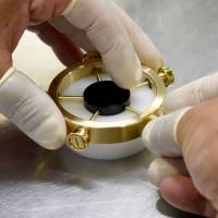 Hiroshi Tsukada, employee of ball bearing maker NSK Micro Precision, assembles a fidget spinner at a factory in Fujisawa, Kanagawa Prefecture, on Monday. Bearing maker NSK claims to make world's top fidget spinner