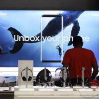 A customer browses mobile devices at a Sprint store in Glendale, California. | BLOOMBERG