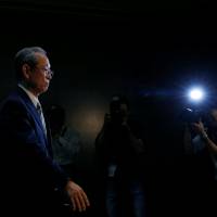 Toshiba Corp. CEO Satoshi Tsunakawa leaves a news conference Tuesday at the company’s headquarters in Tokyo. Toshiba averts delisting for now, but future still hangs in balance