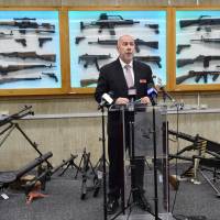 New South Wales Police Detective Chief Inspector Wayne Hoffman speaks to the media at a news conference in Sydney on Tuesday as guns previously seized from criminals are displayed behind him. Thousands of guns handed over in Australia amnesty