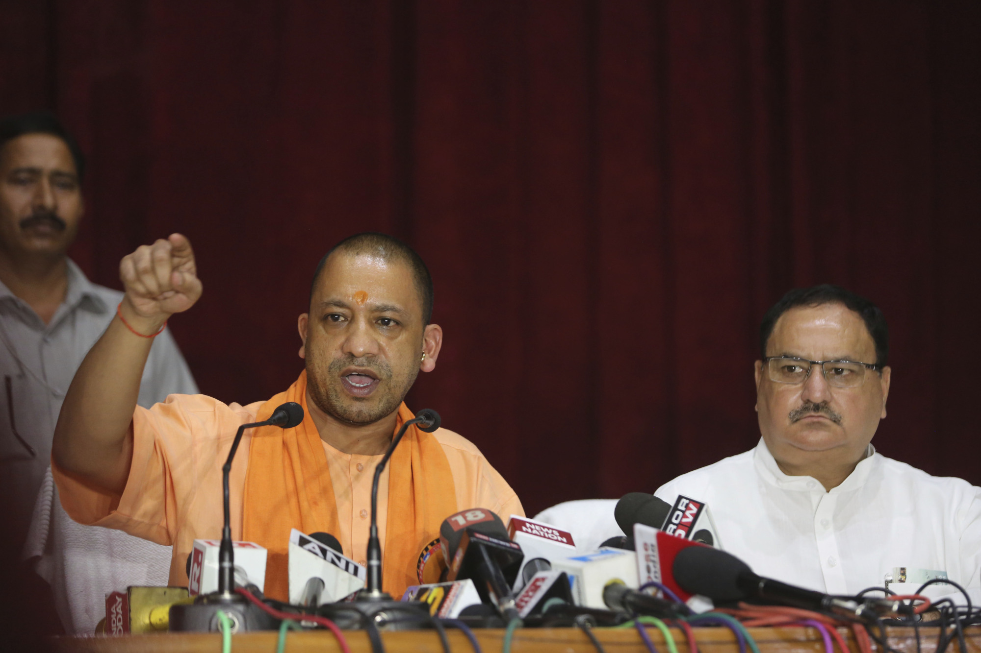 Indian Health Minister J.P. Nadda (right) looks on as Uttar Pradesh state Chief Minister Yogi Adityanath addresses a news  conference after visiting the Baba Raghav Das Medical College Hospital in Gorakhpur, India, on Sunday. | AP