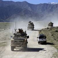 U.S. forces and Afghan commandos patrol the village of Pandola near Jalalabad, Afghanistan, in April. Trump studying options for new approach to Afghan war