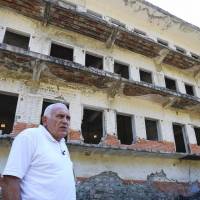 Former political prisoner Saimir Maloku poses in front of the dormitories on June 23 near the village of Reps, northwestern Albania at the former Spac prison, a labor camp established in 1968 by the communist government of Albania at the site of a mine. The camp was listed by an organization in New-York in 2015 as a world building in an extremely advanced state of deterioration, and is currentlty stabilized. Albanians trying to come to grips with dark, murderous communist past