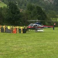 Rescue workers stand next to a police helicopter in Krimml in the Austrian province of Salzburg Sunday. The Austrian Red Cross said five mountain climbers died Sunday in the Austrian Alps in Wildgerlostal on Mount Gabler, east of Innsbruck, and a sixth climber was severely injured, the Austrian news agency APA reported. Alps accidents claim eight mountaineers, including two roped-together groups