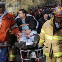 Metro North Railroad engineer William Rockefeller is wheeled on a stretcher away from the area where the commuter train he was operating derailed, killing four people, in the Bronx borough of New York in 2013. The National Transportation Safety Board said that Rockefeller had “severe obstructive sleep apnea.” Safety experts say millions of lives will be at risk now that U.S. officials have dropped plans to require that truck drivers and train engineers be screened for sleep apnea. Officials say testing should be left up to railroads and trucking companies. Trump rollback of planned rule to test train, truck drivers for sleep disorders seen putting lives at risk