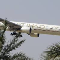 An Etihad Airways plane prepares to land in Abu Dhabi Airport in 2014. The United Arab Emirates\' national airline says it is working with Australian police in its investigation into an attempted airplane attack. | AP