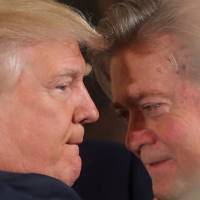 U.S. President Donald Trump talks to chief strategist Steve Bannon during a swearing-in ceremony for senior staff at the White House in Washington on Jan. 22. In latest White House upheaval Trump dumps controversial chief strategist Bannon