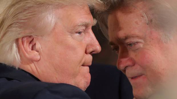 U.S. President Donald Trump talks to chief strategist Steve Bannon during a swearing-in ceremony for senior staff at the White House in Washington on Jan. 22. In latest White House upheaval Trump dumps controversial chief strategist Bannon