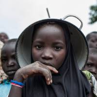 A girl using a pot as a hat poses with other children on Tuesday at a camp for internally displaced people in Gwoza, northeastern Nigeria. Boko Haram seized Gwoza in July 2014. It was retaken by Nigerian troops in March 2015, but extremists continued to raid nearby villages. In battle of beliefs, Nigeria targets Boko Haram's top brass