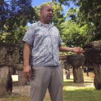 Adrian Cruz, chairman of the Task Force for Free Association, explains some of the early history of the Chamorro people in Latte Stone Park on Guam. Latte stones are pillars of the ancient Chamorro homes, which were built on the island as early as A.D. 500. Korea fight is latest conflict for indigenous people of Guam