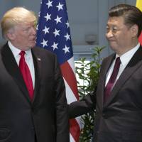 U.S. President Donald Trump and Chinese President Xi Jinping arrive for a meeting on the sidelines of the Group of 20 Summit on July 8 in Hamburg, Germany. U.S. reportedly plans trade action over Chinese theft of intellectual property
