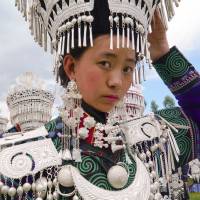 Yi girls prepare to participate in a traditional performance to celebrate the Torch Festival on July 18 in Butuo County, Sichuan province, China. | REUTERS