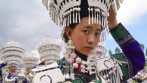Yi girls prepare to participate in a traditional performance to celebrate the Torch Festival on July 18 in Butuo County, Sichuan province, China. China's ethnic Yi struggle against poverty