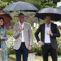 Britain’s Prince William, Duke of Cambridge (third from left), his wife, Britain’s Catherine, Duchess of Cambridge, and his brother, Britain’s Prince Harry (second, right)), talk with Head Gardener Sean Harkin during an event at the memorial gardens in Kensington Palace, west London, Wednesday. Princes William and Harry prepared to pay tribute to their late mother Princess Diana on Wednesday for the 20th anniversary of her death as wellwishers left candles and flowers outside the gates of her former London residence. Princes mark 20th anniversary of Diana's death with garden and charity visit as Britain pays respects