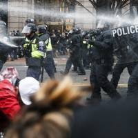 Police fire pepper spray at protestors during a Jan. 20 demonstration downtown Washington after the inauguration of President Donald Trump. U.S. prosecutors try to force firm to turn over website records linked to Inauguration Day protests