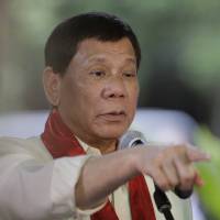 Philippine President Rodrigo Duterte points at a reporter during a press conference at the 113th Founding Anniversary of the Bureau of Internal Revenue in metropolitan Manila Wednesday. The tough-talking Duterte briefly lashed out at North Korean leader Kim Jong Un in a speech before local revenue collectors Wednesday. | AP