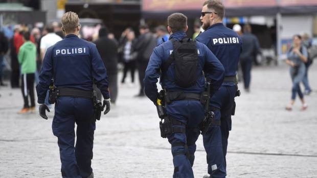 Police officers patrol at Turku Market Square in Turku, Finland, on Saturday. Finnish stabbings treated as terrorism; suspect targeted women