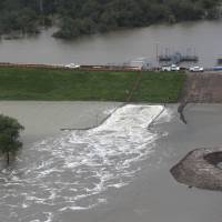 Water is released from the Addicks Reservoir as floodwaters rise from Tropical Storm Harvey on Tuesday in Houston. Residents urged to 'GET OUT NOW!!!' as Houston dams, levee overflow; flood death toll now at three