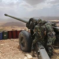 Lebanese army soldiers work on a 130mm howitzer pointed at areas controlled by Islamic State group militants near Arsal, in northeast Lebanon, in June. Lebanon’s U.S.-backed military is gearing up for a long awaited assault to dislodge hundreds of IS militants from a remote corner of northeastern Lebanon near the border with Syria, seeking to end a years-long threat posed to neighboring towns and villages by the extremists. Lebanon's U.S.-backed forces poised to purge border of Islamic State fighters but sleeper cells pose threat