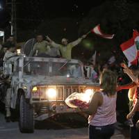 Lebanese wave their national flag as they celebrate in the town of Qaa as members of the Lebanese army return from battling Islamic State jihadis on the country’s eastern front bordering with Syria on Tuesday. Lebanon’s army said it had captured most of a mountainous area on the border with Syria during an operation to clear Islamic State jihadis from the region. U.S.-backed Lebanon forces say they have flushed Islamic State fighters from most of Syria border area