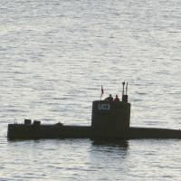 Swedish journalist Kim Wall appears to stand next to Peter Madsen in the tower of his private submarine, UC3 Nautilus, in Copenhagen Harbor on Thursday evening. | AFP-JIJI