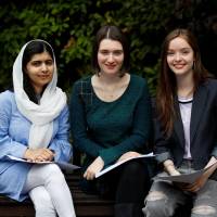 Malala Yousafzai poses with fellow students Bethany Lucas (center) and Beatrice Kessedjian after getting her “A” level exam results on Thursday at Edgbaston High School for Girls in Birmingham, England. Nobel winner Malala Yousafzai, shot for promoting education, to study at Oxford