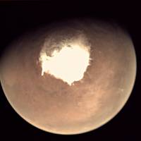 This file picture released in 2016 by the European Space Agency (ESA) shows Mars as seen by the webcam on ESA’s Mars Express orbiter, as another mission, ExoMars, is about to reach the Red Planet. Mars is buffeted by turbulent snowstorms that occur only at night, according to a study released Monday that revises our understanding of Red Planet weather. Up to now, it was thought that snow falling from low-lying Martian clouds settled slowly and sparsely to the ground in a environment bereft of violent winds. The new findings, reported in the journal Nature Geoscience, suggest that ice-water particles swirling in a storm hit the ground within minutes, rather than descending gently for hours. Martian night forecast: Dark with flurries