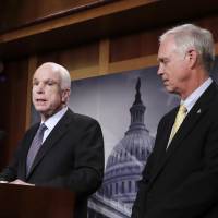 Sen. Ron Johnson listens July 27 as Sen. John McCain speaks on Capitol Hill in Washington. Johnson suggested that McCain’s brain tumor and the after-midnight timing of the vote were factors in the Arizona lawmaker’s decisive vote against the GOP health care bill. GOP senator suggests brain tumor, late-night hour affected McCain vote on health care bill
