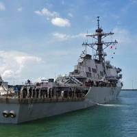 The guided-missile destroyer USS John S. McCain arrives at Changi Naval Base in Singapore on Monday. U.S. warship collisions raise cyberattack fears