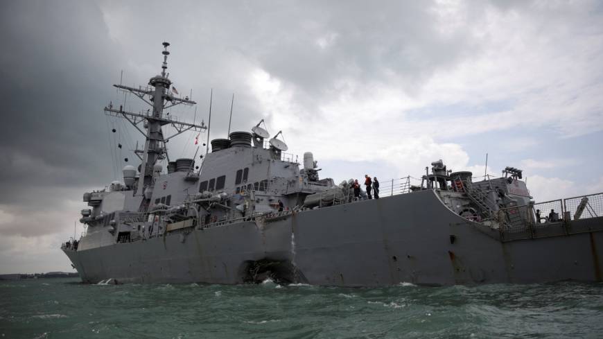 The guided-missile destroyer USS John S. McCain is seen after a collision, in Singapore waters on Monday. U.S. Navy to probe Japan-based fleet as hunt for sailors missing in latest collision continues