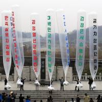 Park Sang Hak (center), a refugee from the North who now runs an activist group, and South Korean conservative activists prepare to release balloons bearing leaflets condemning North Korea and its leader during a rally on April 15, 2011, the 99th anniversary of North Korean founder Kim Il Sung’s birth, at the Imjingak Pavilion near the border village of Panmunjom in Paju, South Korea. Activists fight North Korea with balloons, DVDs and leaflets